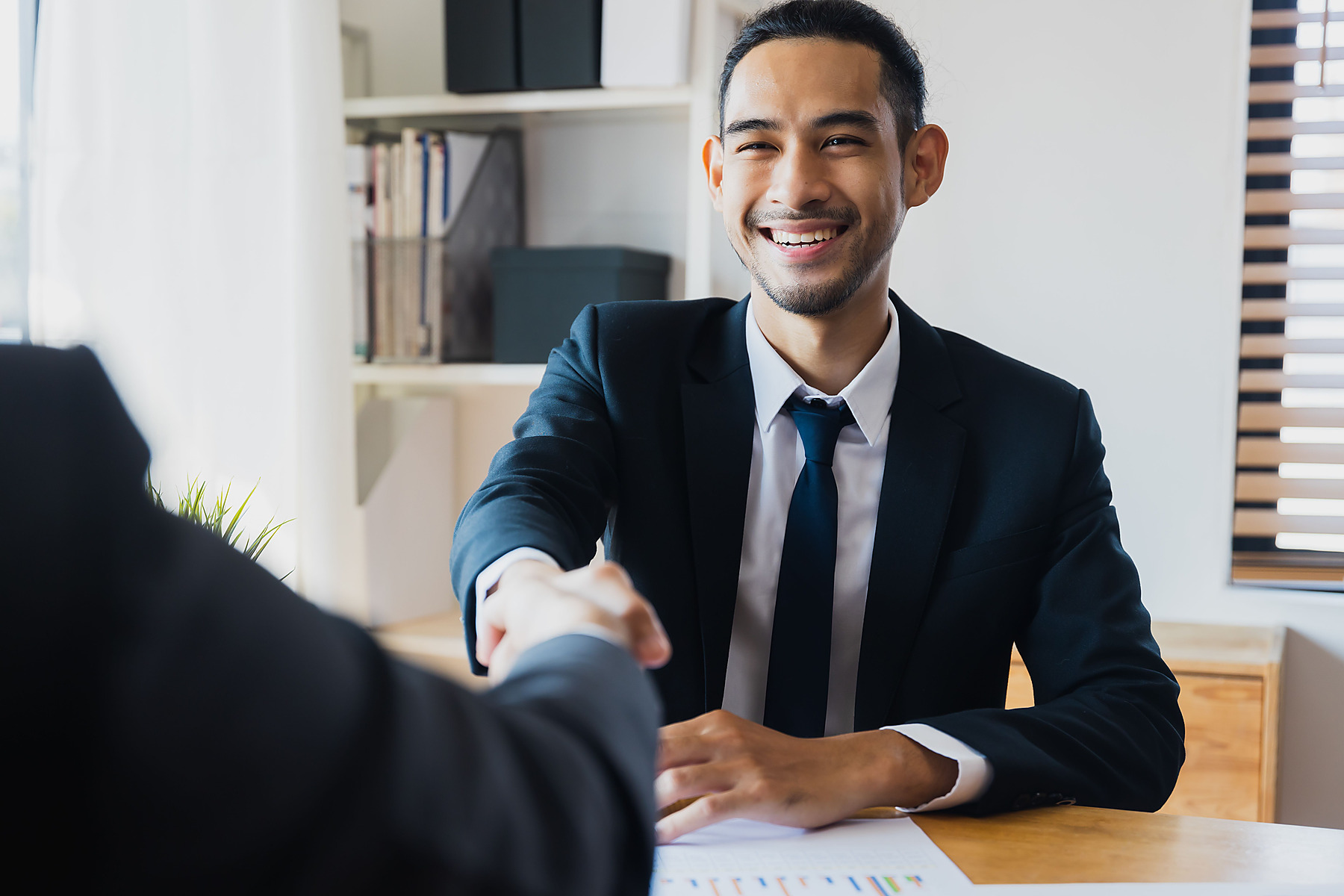 Business people shaking hands after a financial meeting