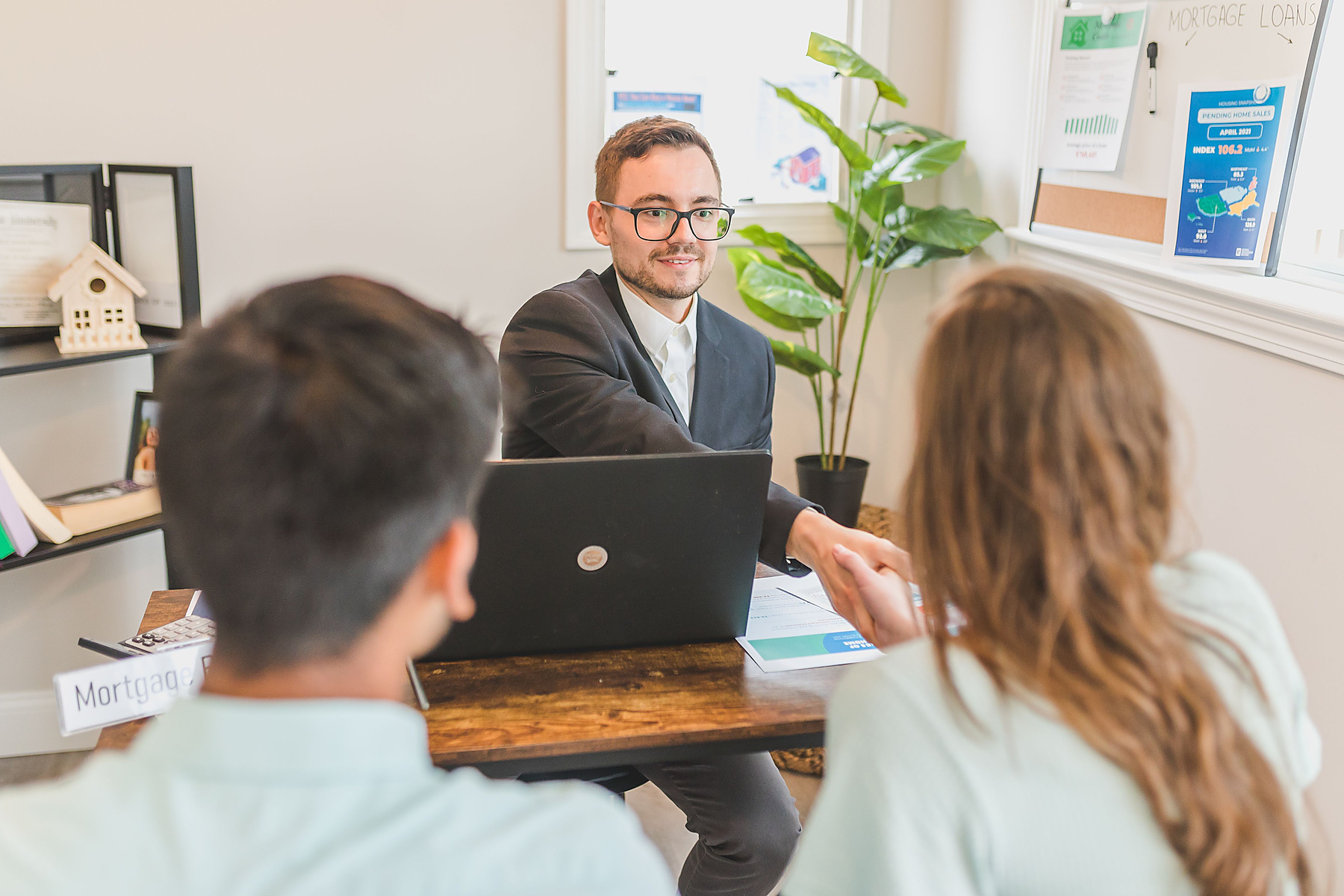 Banker and customers reviewing account documents